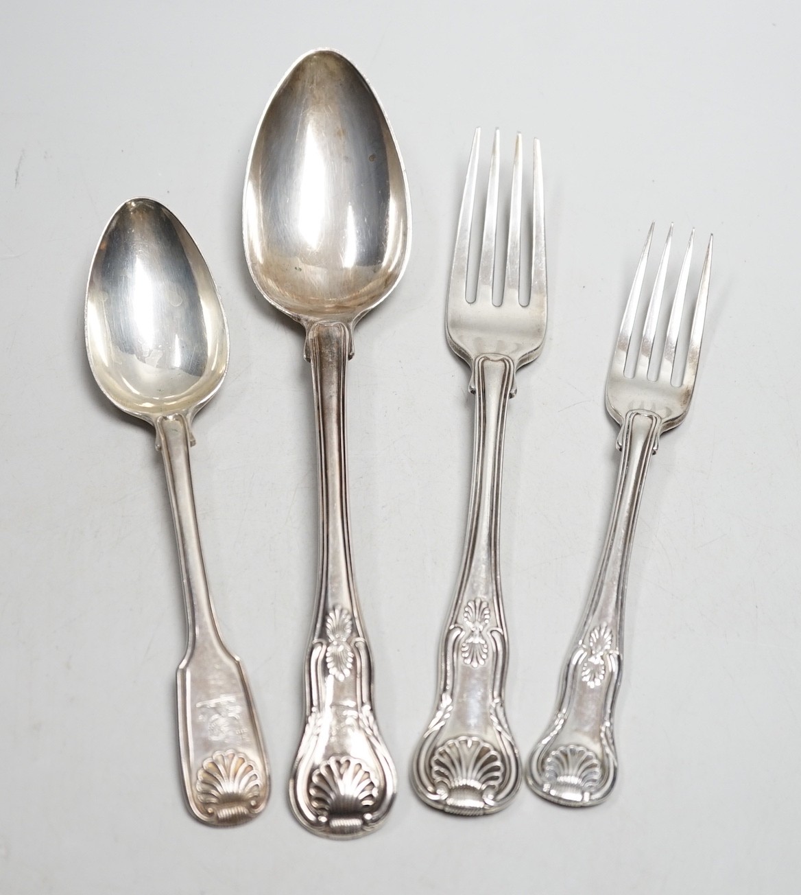 A harlequin part canteen of 19th century silver Kings pattern flatware include a pair of basting spoons, Robert Rutland, London, 1825, three dessert spoons, five serving spoons, six dinner forks and eight dessert forks,